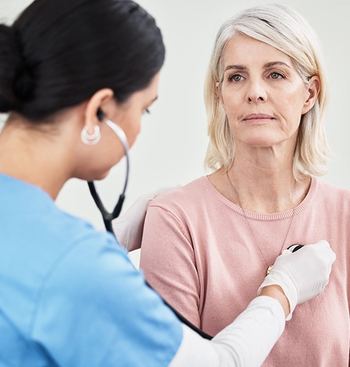 An aging woman receives cardiac monitoring as part of her dep vein thrombosis treatment plan.