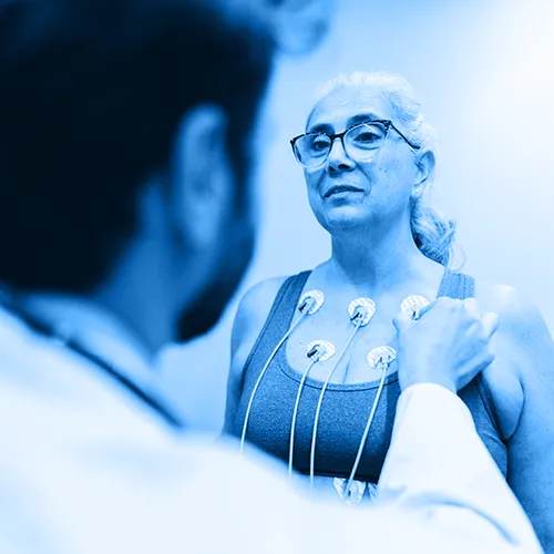 An aging woman receives a cardiac checkup to monitor coronary heart disease.