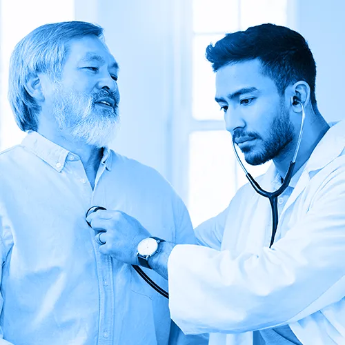 A healthcare professional monitors a patient’s cardiac health while treating pericardial disease.