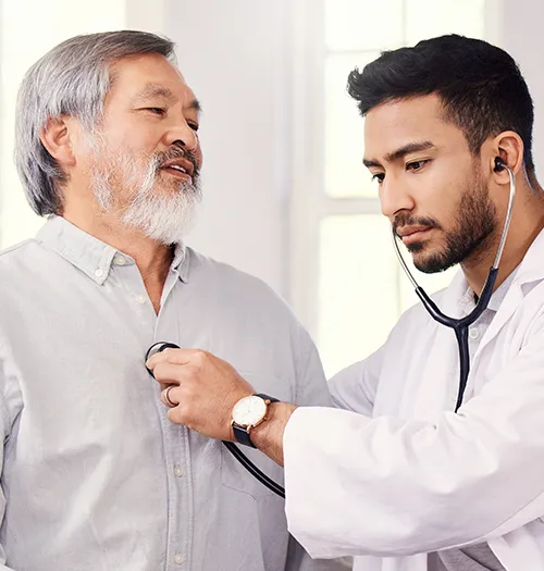 A healthcare professional monitors a patient’s cardiac health while treating pericardial disease.